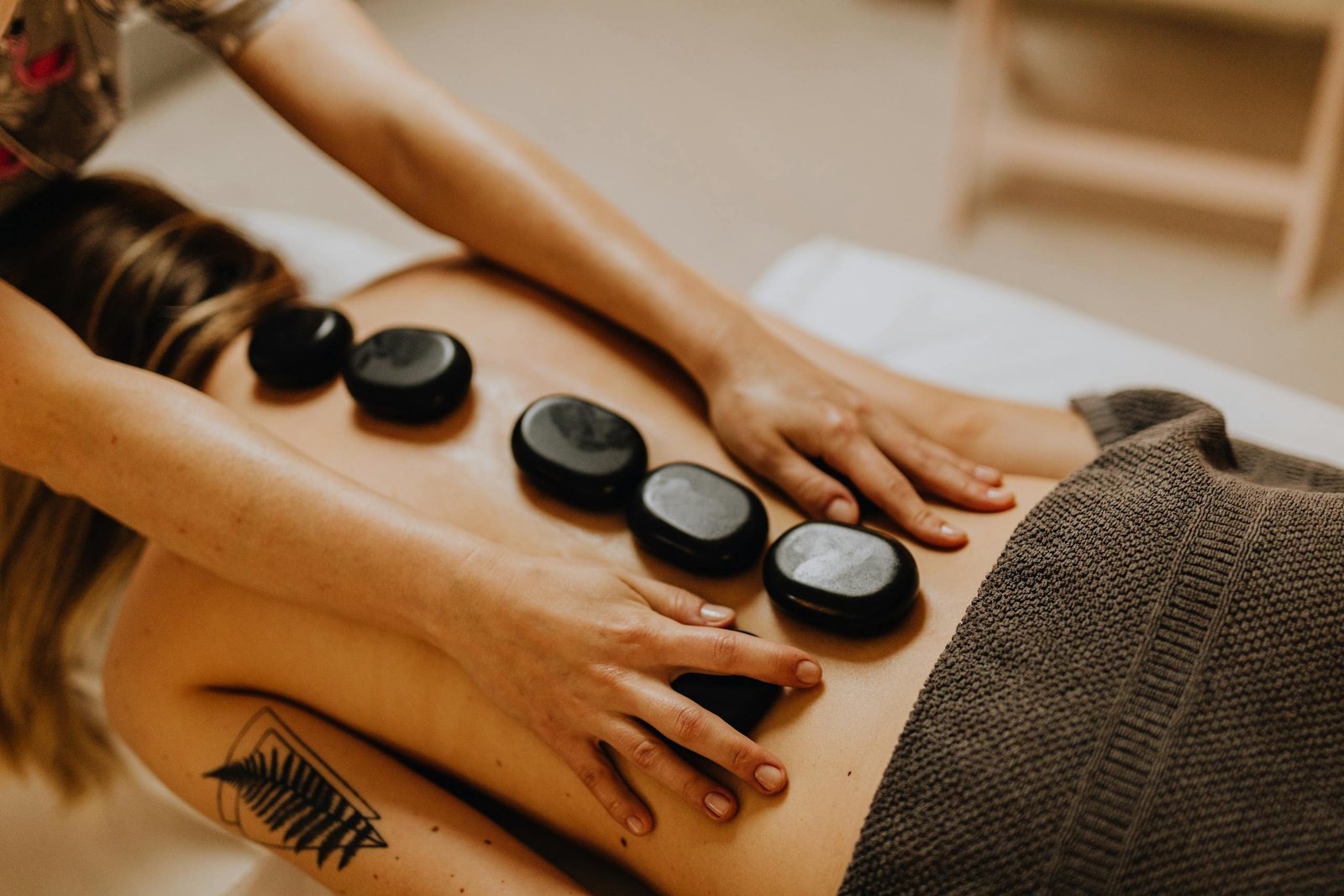 A soothing hot stone massage therapy session for relaxation and wellness.